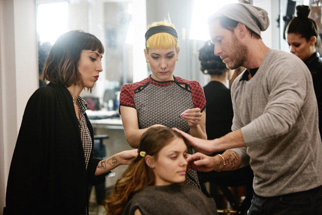 Three stylists around model